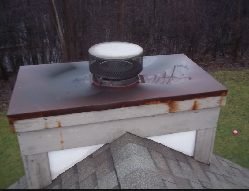 Old, worn out chimney rain pan, rusting and destroying the chimney. We sell, replace and install new stainless steel chimney pans and serve Ohio, Michigan and Indiana.